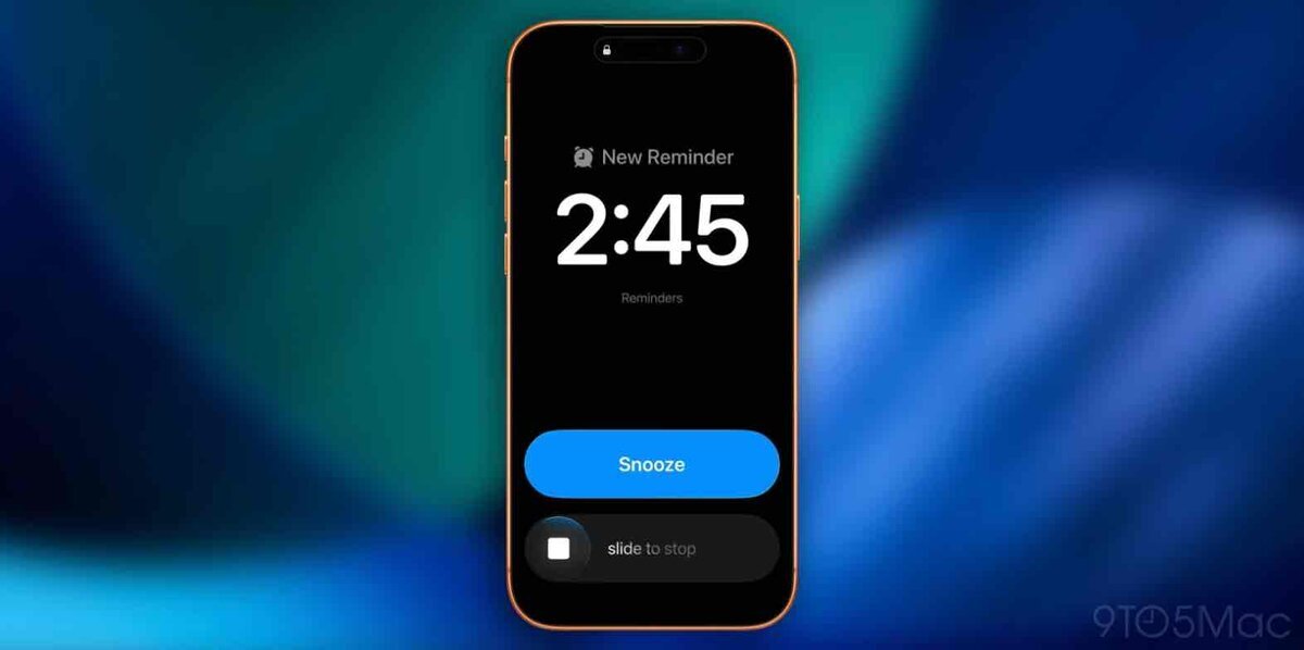 iOS 26.4のリマインダー「緊急」アラーム画面。ロック画面に「New Reminder」と表示され、時刻2:45、下部に「Snooze」ボタンと「slide to stop」が表示されているiPhoneのスクリーンショット