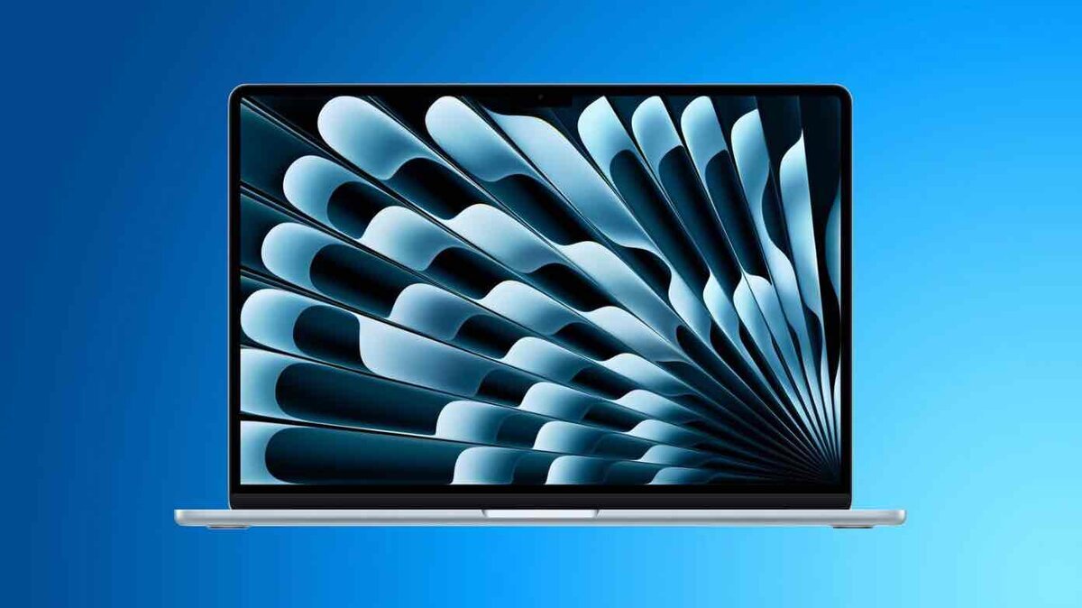 シルバーのMacBook Air M3モデル。画面には公式の「Radial」壁紙(青と黒の抽象的なグラフィック)が表示され、正面から捉えた薄型のデザイン