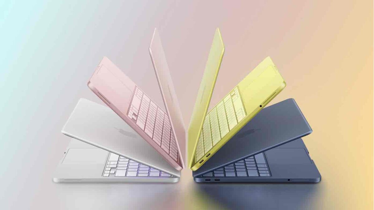 4色のMacBook Neoが扇状に開かれ、シルバー、ブラッシュ、シトラス、インディゴの本体カラーとキーボードが並んで見えるプロダクト画像