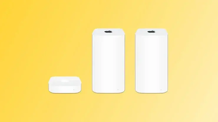 黄色い背景に置かれた、白いAppleのAirPort機器3台