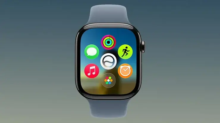 watchOS 27のホーム画面を表示したApple Watch。中央にSiriのアイコンがあり、その周囲にアクティビティ、メッセージ、ワークアウト、ミュージック、タイマー、写真の各アプリが円形に並ぶ