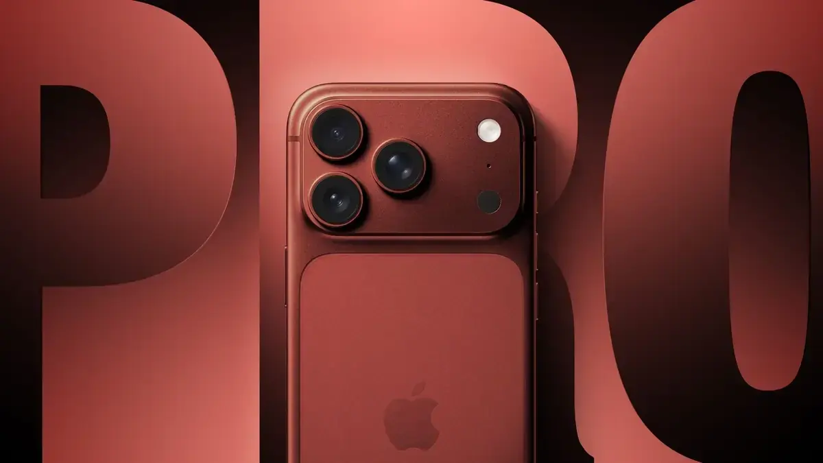 深い赤色のiPhone背面のアップ。3眼カメラのプラトーと、背面中央の角丸長方形のMagSafe領域にAppleロゴ。背景に大きな「PRO」の文字