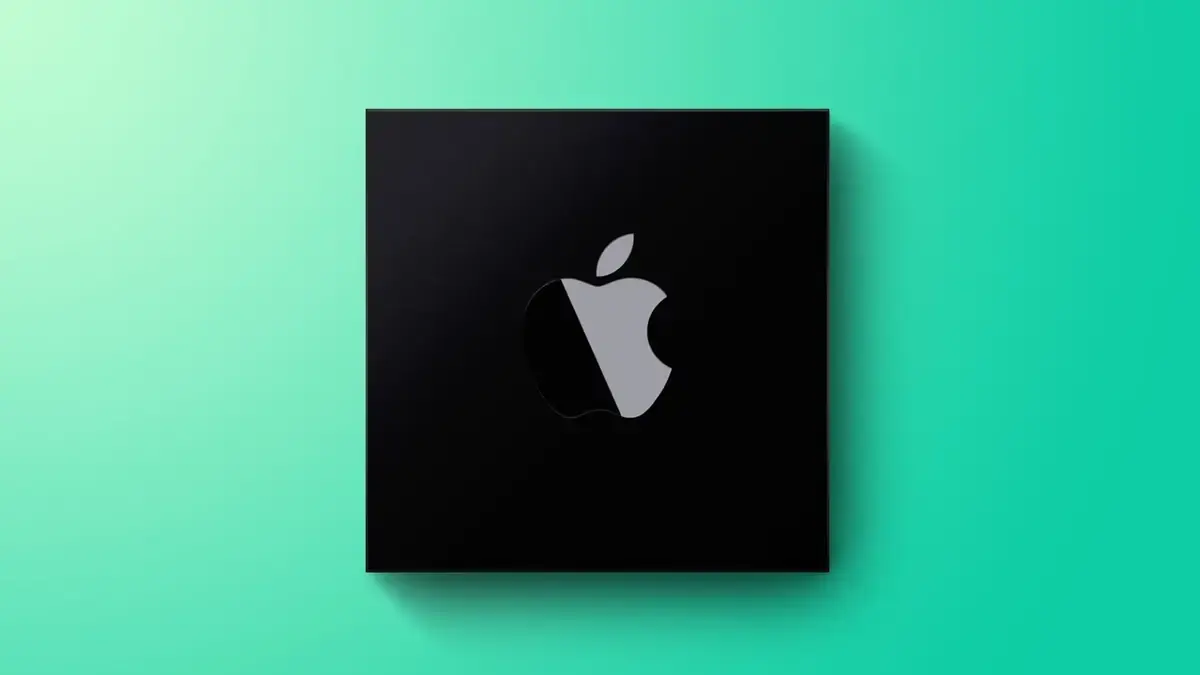 ミントグリーンの背景に置かれた黒い正方形のチップ。表面にAppleのロゴが刻まれている