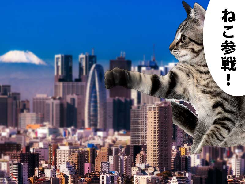 富士山が見える新宿のコクーンビルを巨大化した猫が壊そうとしている。吹き出しには『ねこ参戦！』