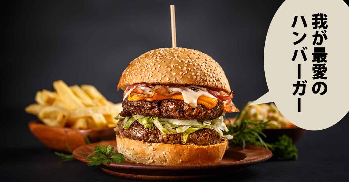 串が刺さった肉厚のハンバーガーとポテト。吹き出しに「我が最愛の ハンバーガー」