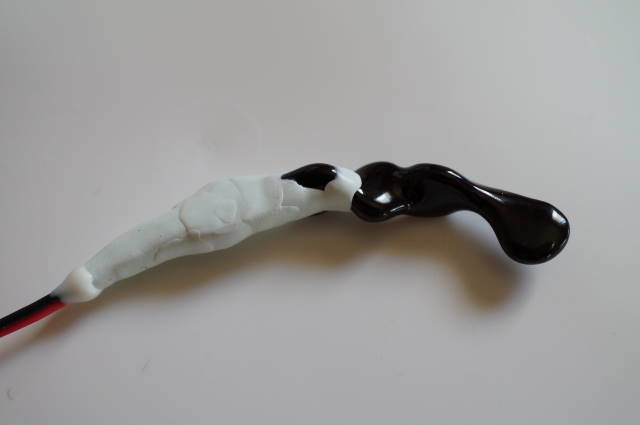 A ceramic twist prototype with resin covering its motor connection.