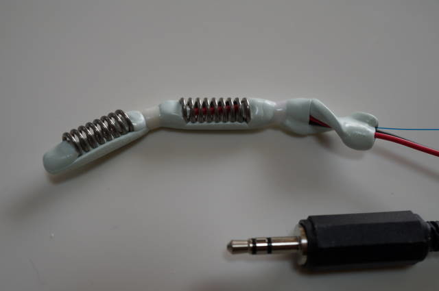 The linked electrode prototype beside its plug and trailing cables.