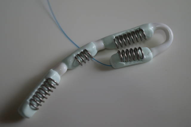 The softer connection shown folded between steel ring chips.