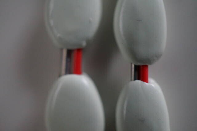 Bare and covered wire supports compared for the flexible paired-chip design.