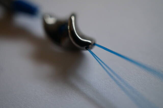 Four nylon threads through a stainless-steel screw attachment