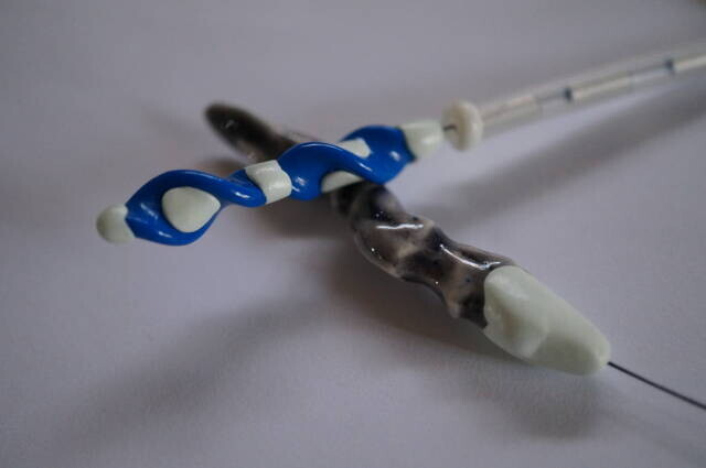 The custom reversible drill's paired blue tips and opposite shaped tip.
