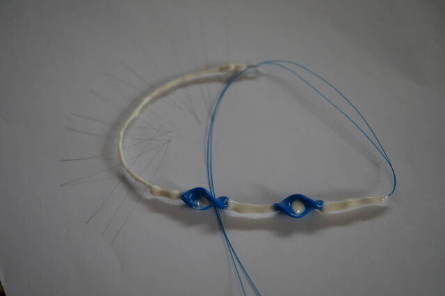 The June 2026 prototype combined fine wires with rear screw parts.