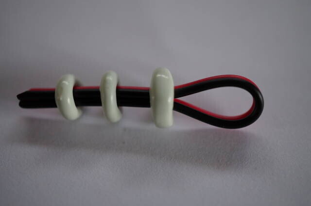 Small, medium, and large four-hole cable stoppers shown together.
