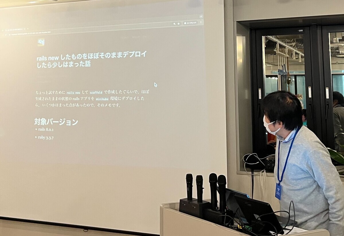 znzさんによる発表。「rails new したものをそのままデプロイしたらハマった話」という画面が投影されている