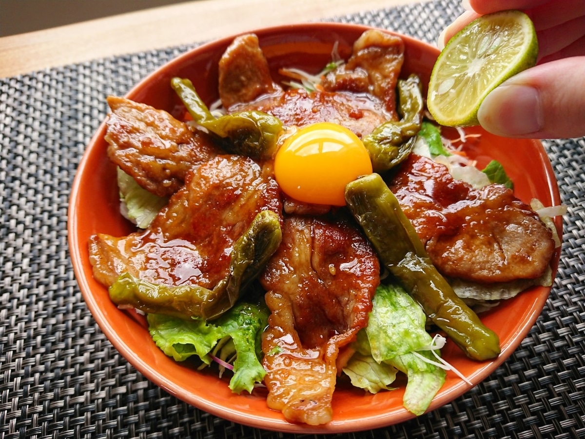 焼肉丼にすだちを搾っている様子