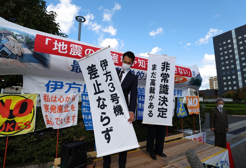 伊方原発3号機の運転差し止めを認めない決定が出され、垂れ幕を掲げる原告団＝広島市中区で2021年11月4日午後2時3分、猪飼健史撮影