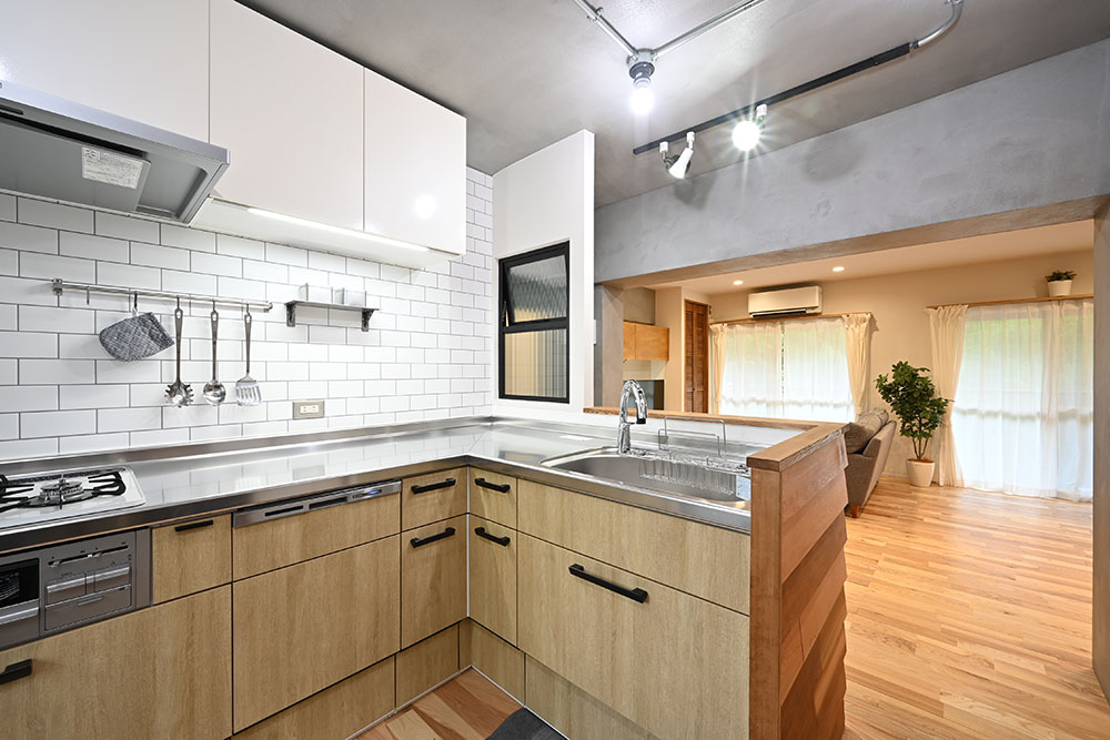一部壁を残したが開閉できる小窓を設けて開放感も出したL型キッチンの写真