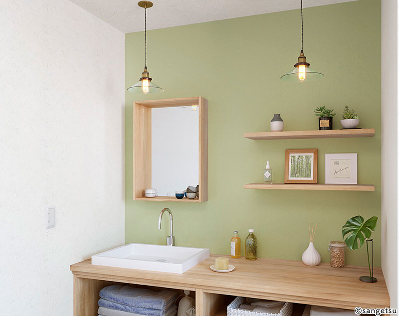 グリーンのアクセントカラーを取り入れた洗面所の内装