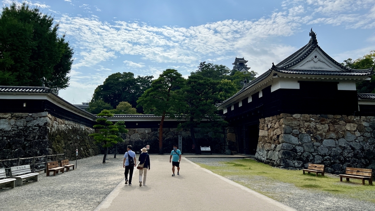 高知城の正面入口と石垣、観光客が歩く広場の風景