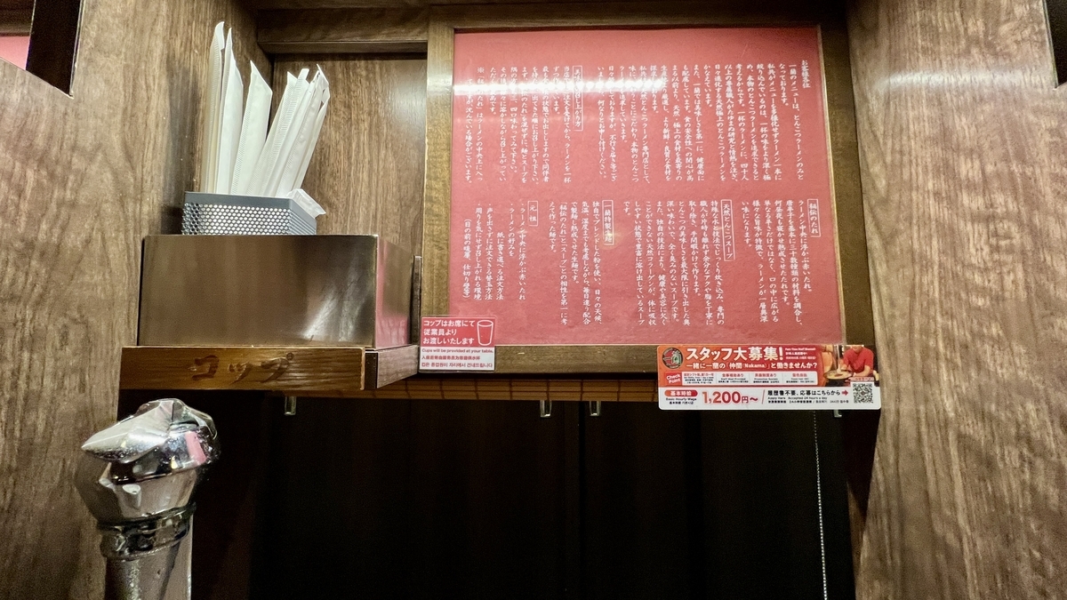 味集中カウンターの奥に掲げられた一蘭のこだわり説明文パネル