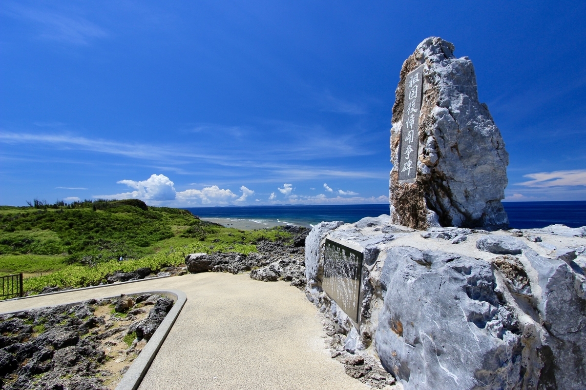 青空の下に立つ辺戸岬の祖国復帰闘争碑と周囲の遊歩道
