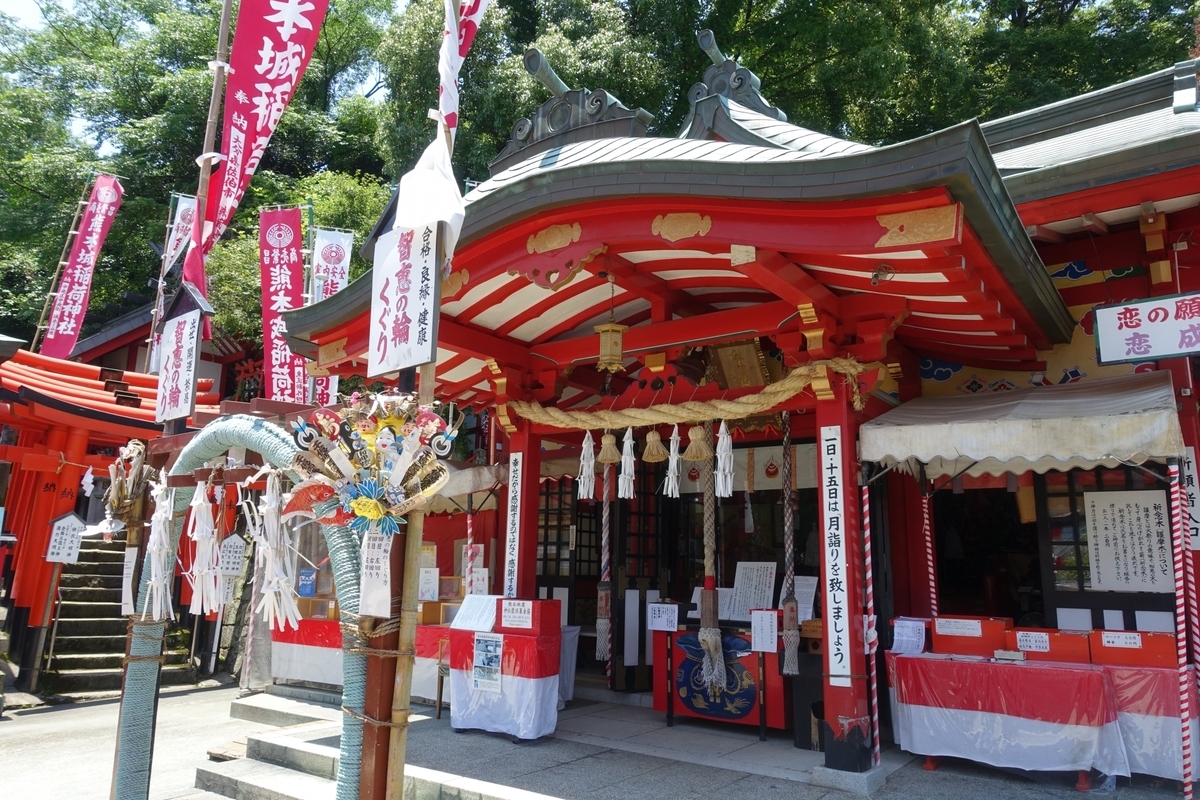 朱色の本殿正面と白いしめ縄が掛かる拝所