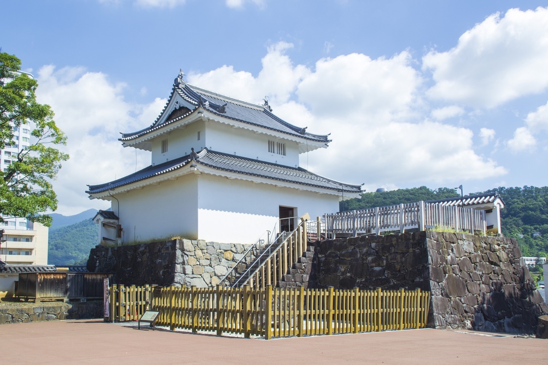 石垣の上に建つ白壁の稲荷櫓と青空