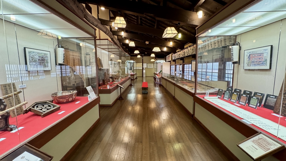 金沢の老舗の品々がガラスケースに並ぶ百年展の展示室