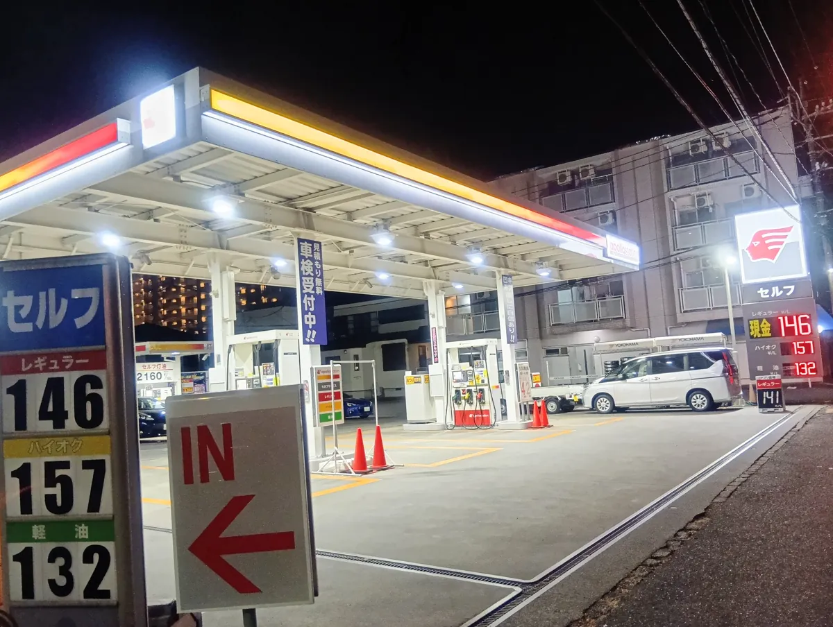 夜のアポロステーション全景。現金146円とアプリ141円の看板が両方写っている