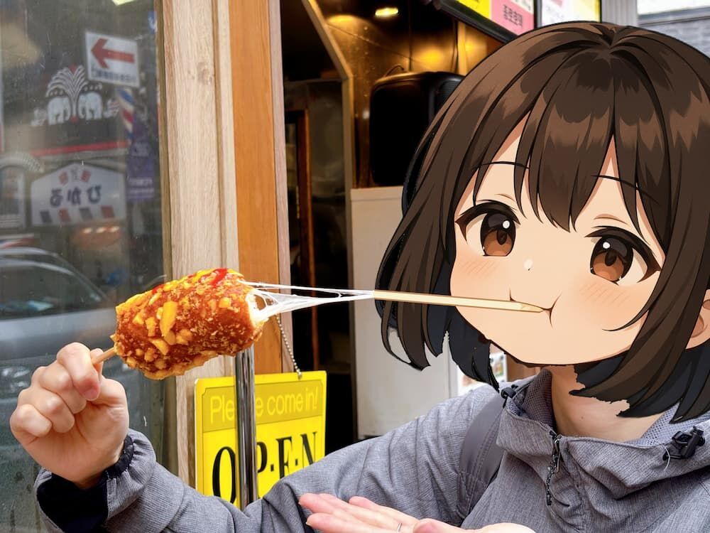 ジョンノ屋台村　チーズハットグ　食べるとチーズがビヨン伸びているところの写真