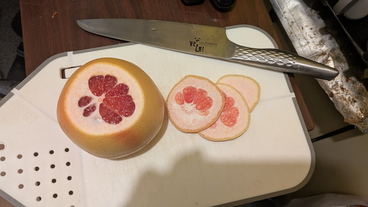 上下を切り落としたグレープフルーツ。赤い果肉が見えている。