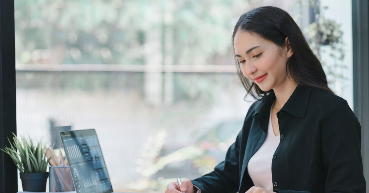 PCが置かれたデスクに向かう女性