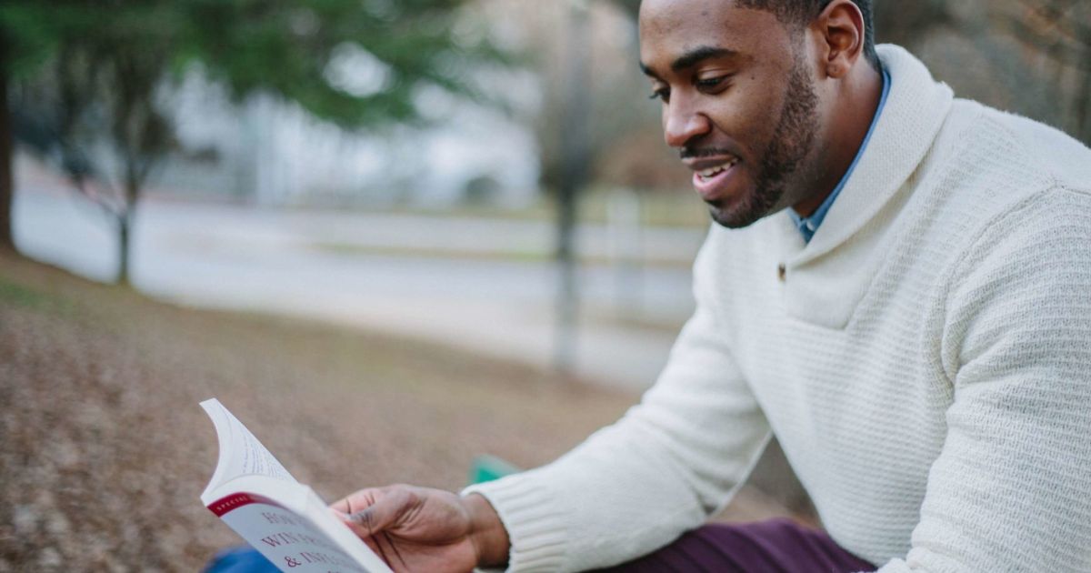 屋外で読書をする男性