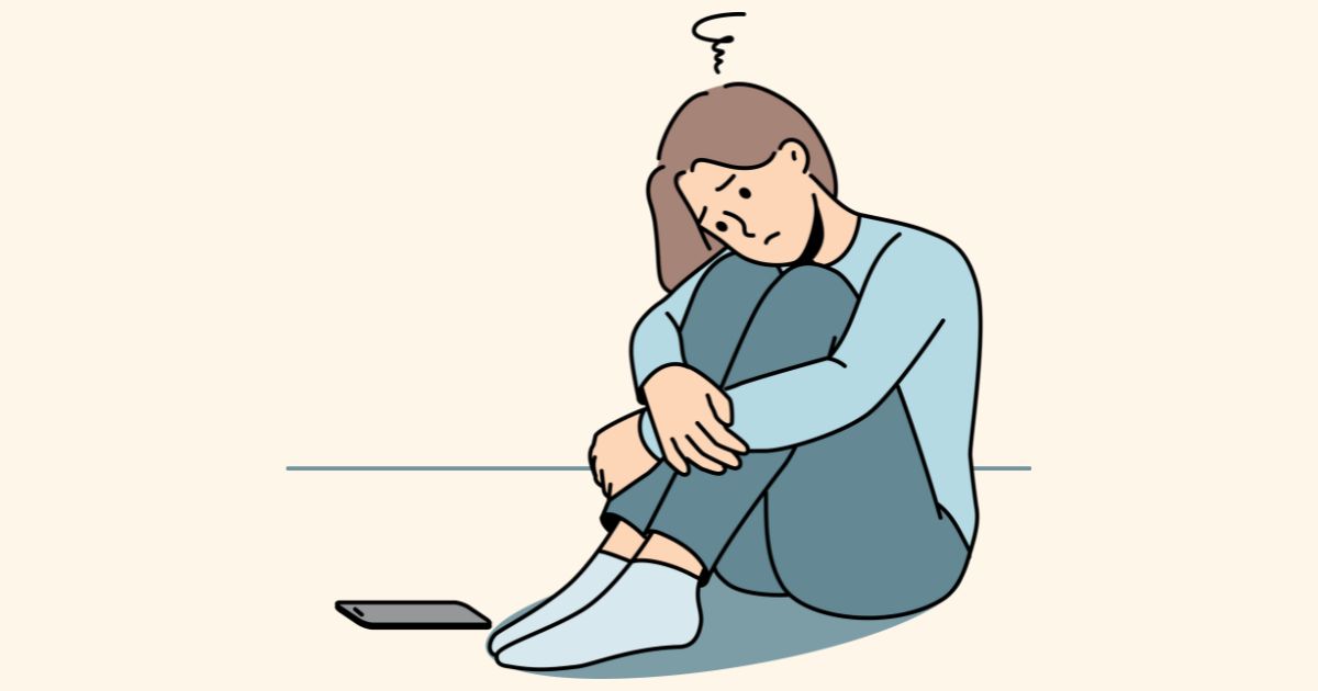 スマホの前で項垂れる女性のイラスト