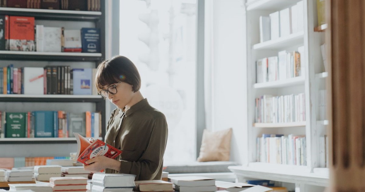 書店で本をパラパラとめくり「しっかり読む本」を見極める女性