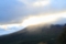 山が光に溶けていく