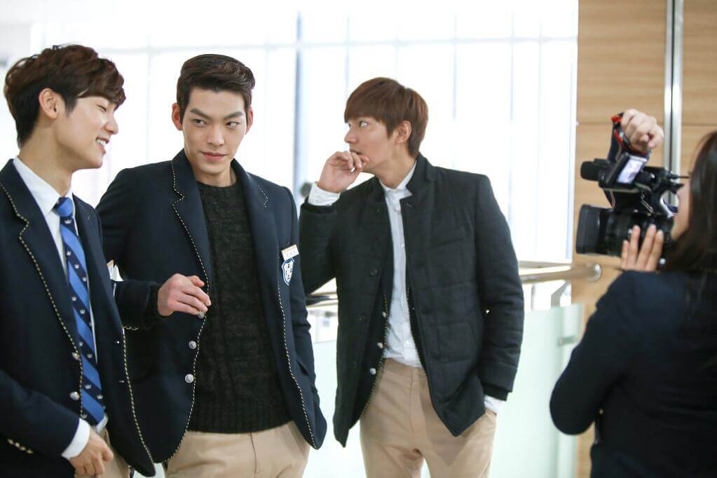 three males wearing student costume standing