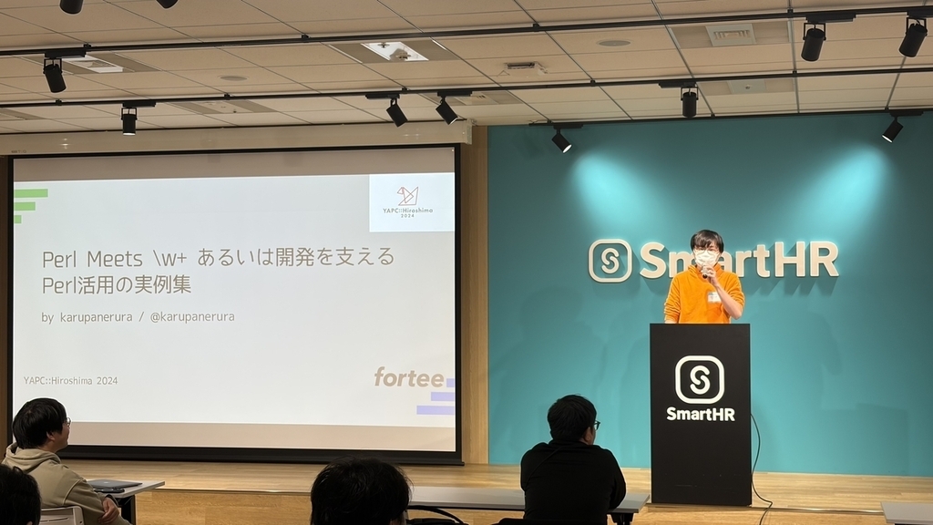 スクリーンに発表タイトルが映っている