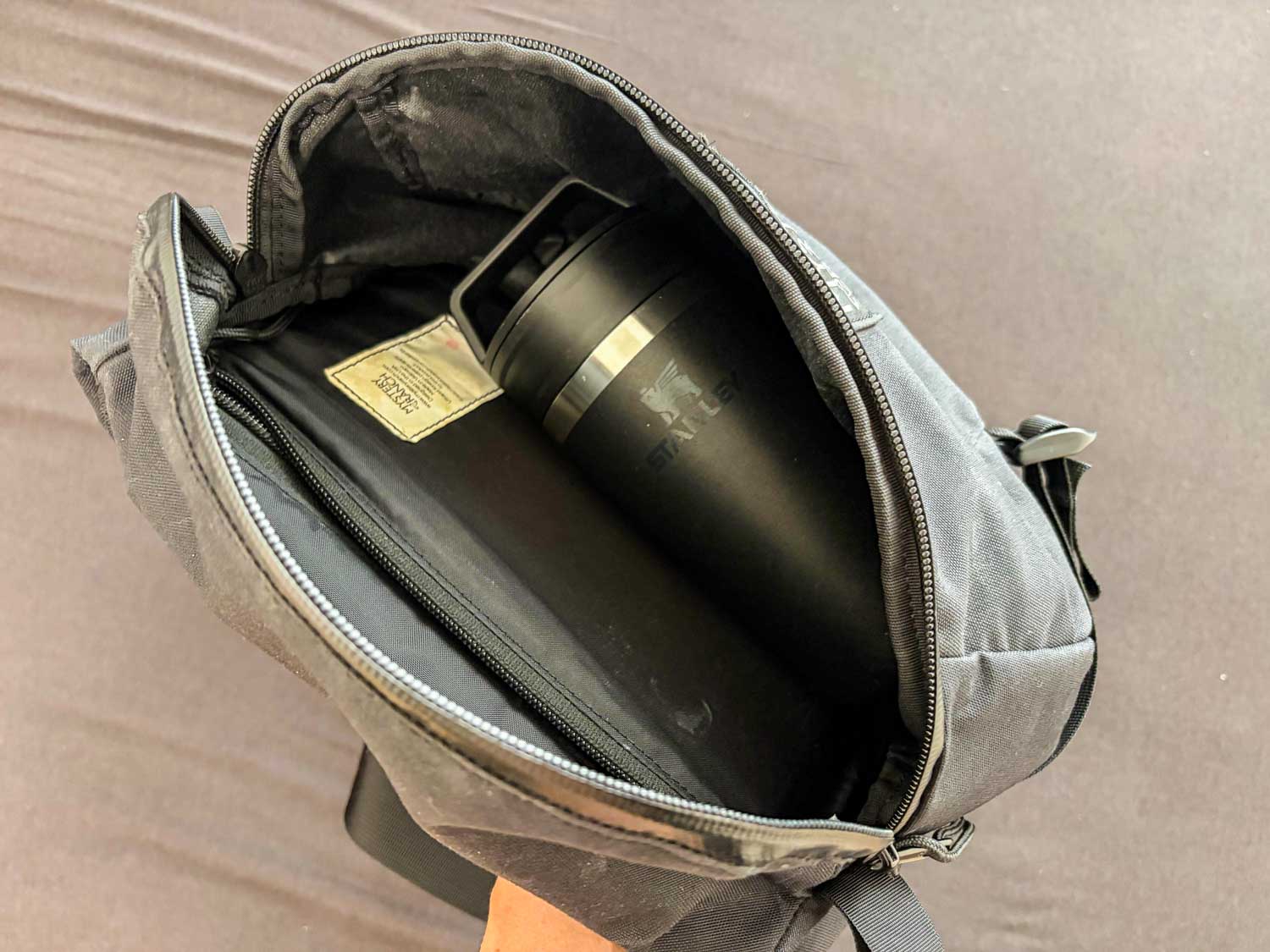 スタンレー真空マグをボディバッグに入れているところ