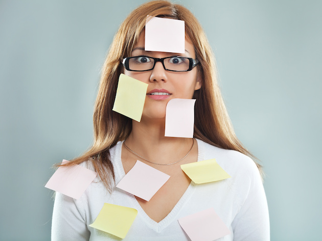 Beautiful young woman covered with post it notes