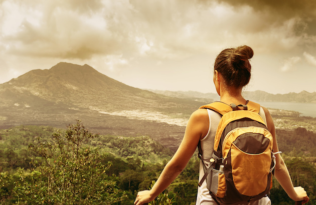 Woman traveler looking at Batur volcano. Indonesia