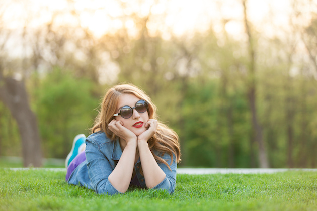 women lying down on green grass
