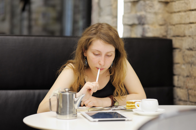 Young woman working on her tablet computer