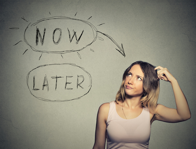 Now or later. Woman thinking scratching head looking up