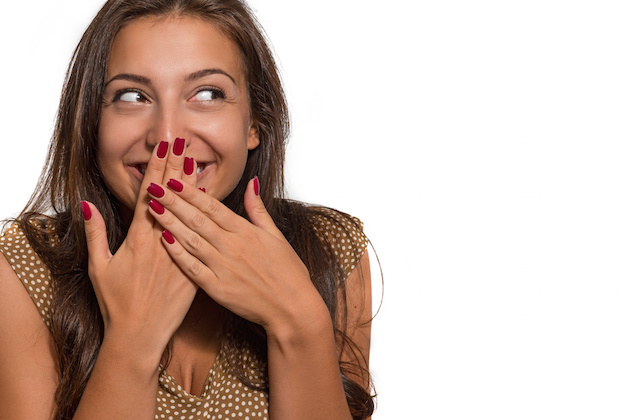 Portrait of beautiful young cheerful woman on a white background