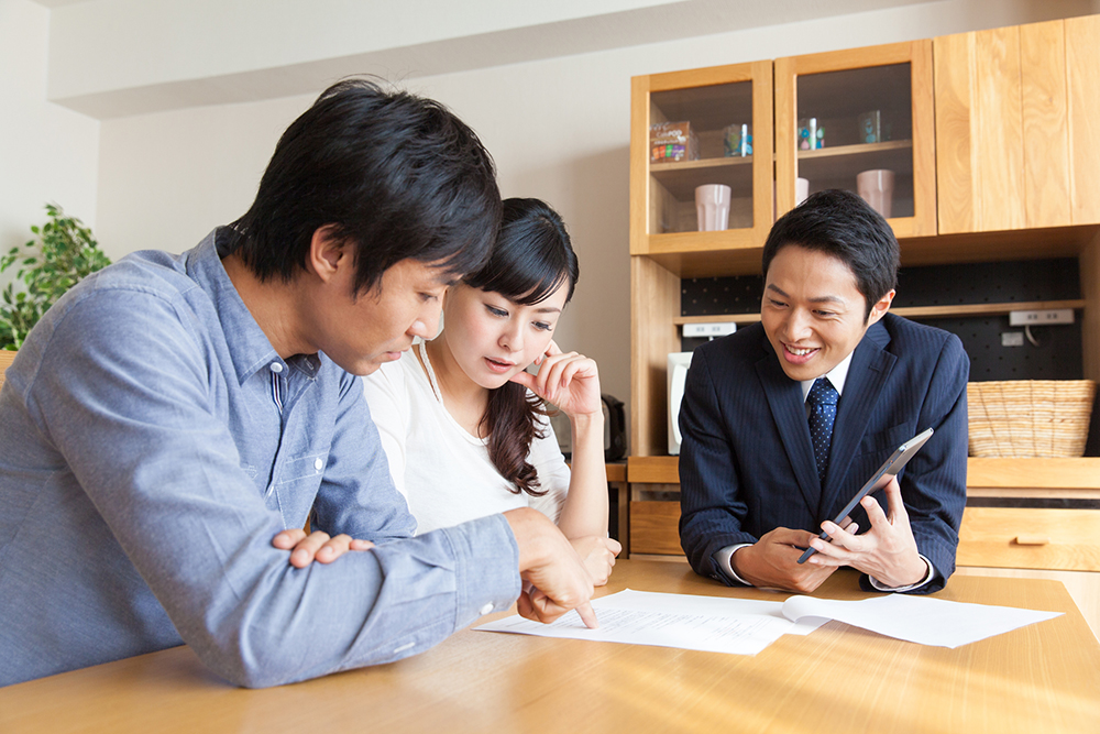 不動産会社と売却の相談をする夫婦のイメージ