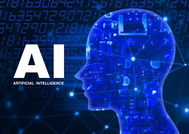 人工知能を搭載した人体の頭部(左向き模式図)と「AI」の文字