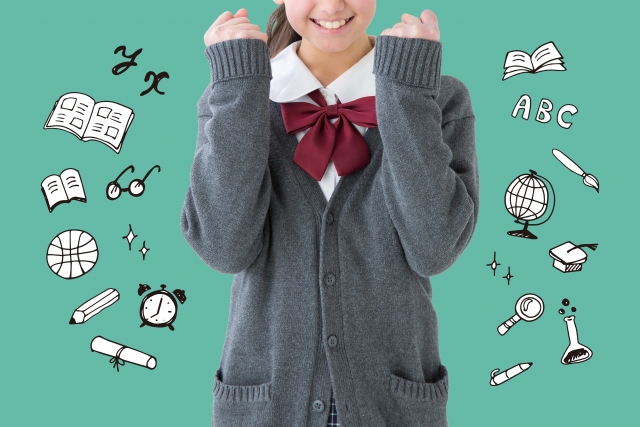 教科書,文具及び教具等のイラストに囲まれた制服のセーターを着た女子学生