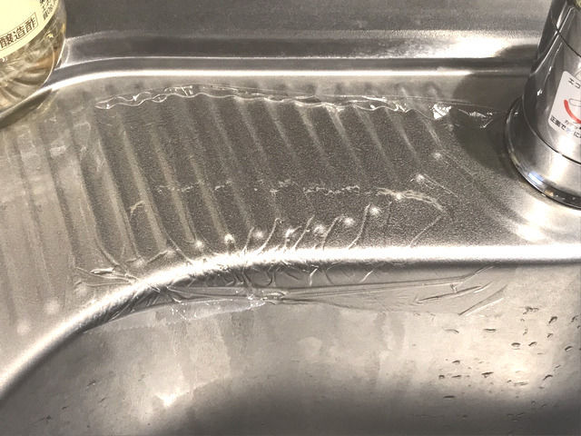 酢とラップで水垢掃除をしている様子