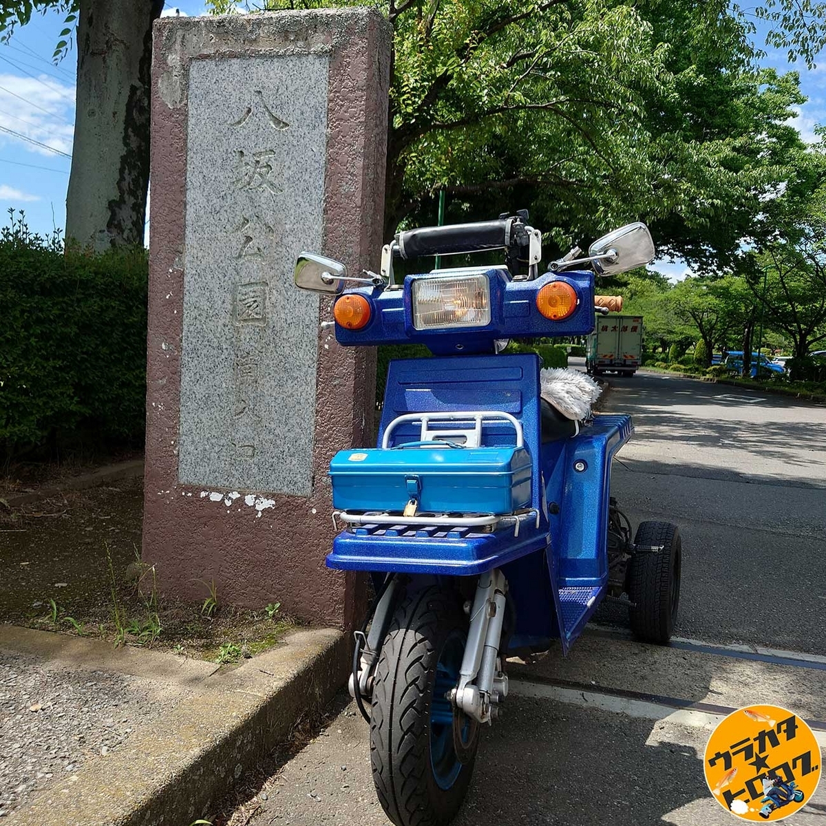 坂東市岩井の八坂公園南駐車場入り口の看板と筆者の愛車ジャイロX(筆者撮影)